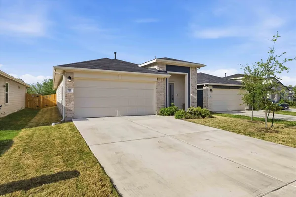 front view of a house with a yard