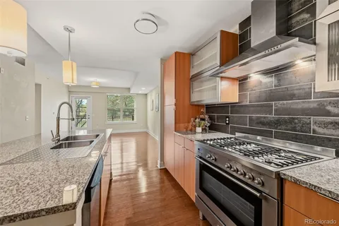 a kitchen with granite countertop a stove and a sink