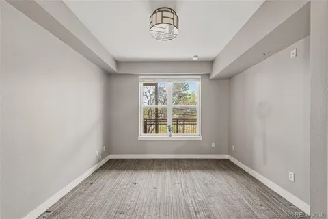 a view of a room with wooden floor and window