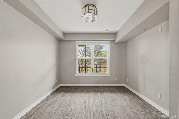 a view of a room with wooden floor and window