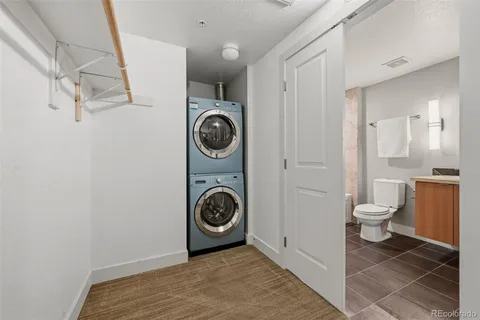 a bathroom with a toilet and a washing machine