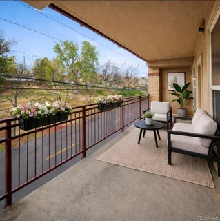 a terrace with outdoor seating and city view