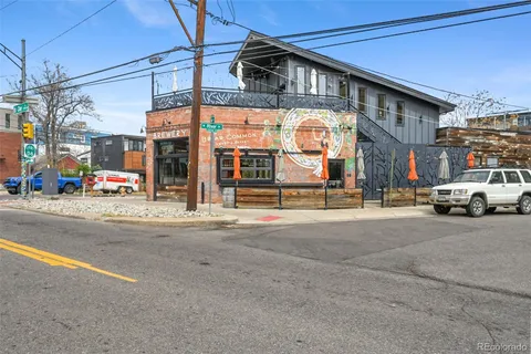 a building with car parked on the road