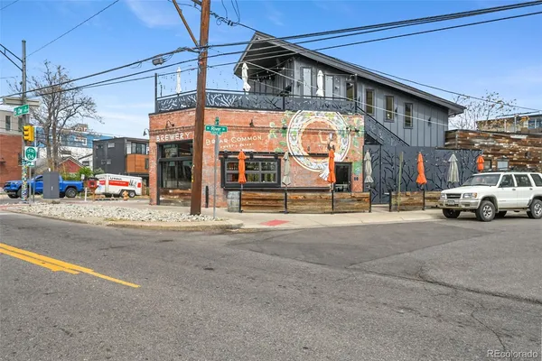 a building with car parked on the road