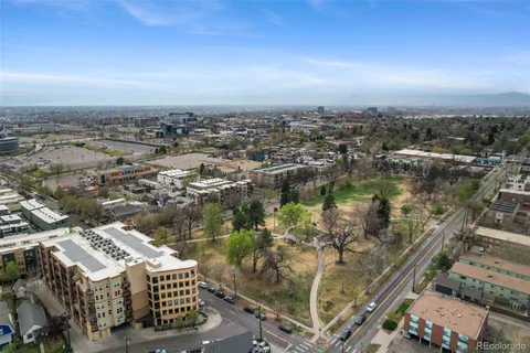an aerial view of a city with ocean view in back