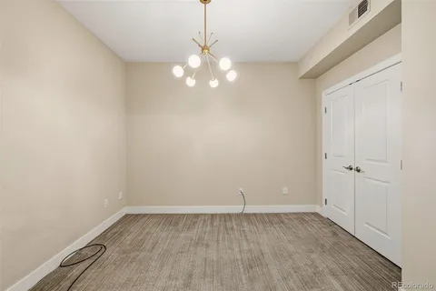 a view of a room with wooden floor and fan