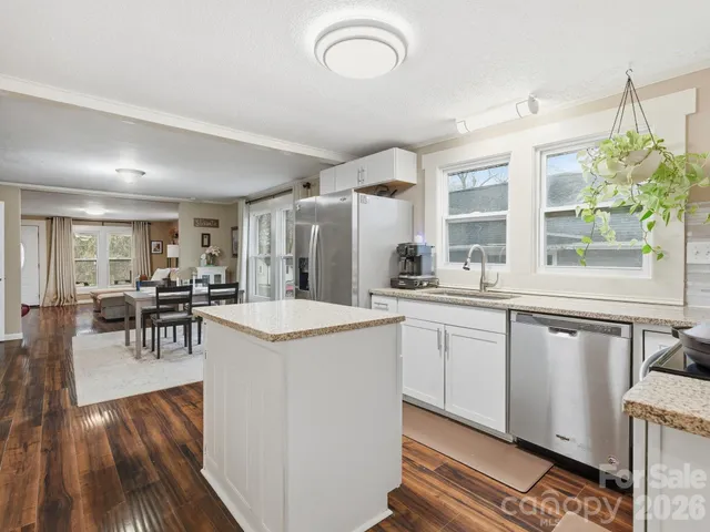 a kitchen with counter and chairs