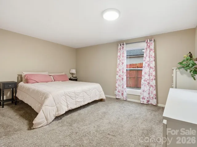 a bedroom with a bed and a potted plant