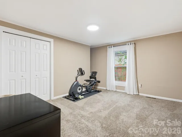 a room with a window and a bicycle