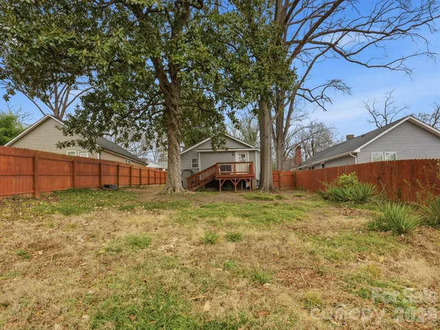 a yellow house sitting in middle of forest
