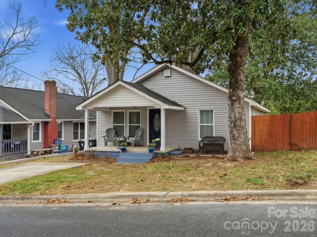 a front view of house with yard outdoor seating and slide