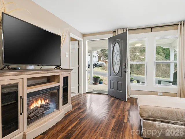 a livingroom with fireplace flat screen tv and outdoor view