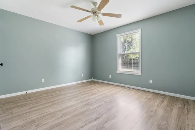 wooden floor in an empty room with a window