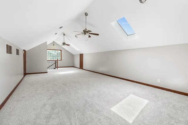 a view of a room with windows and ceiling fan