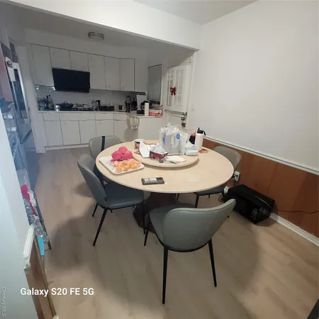 a kitchen with a dining table and chairs