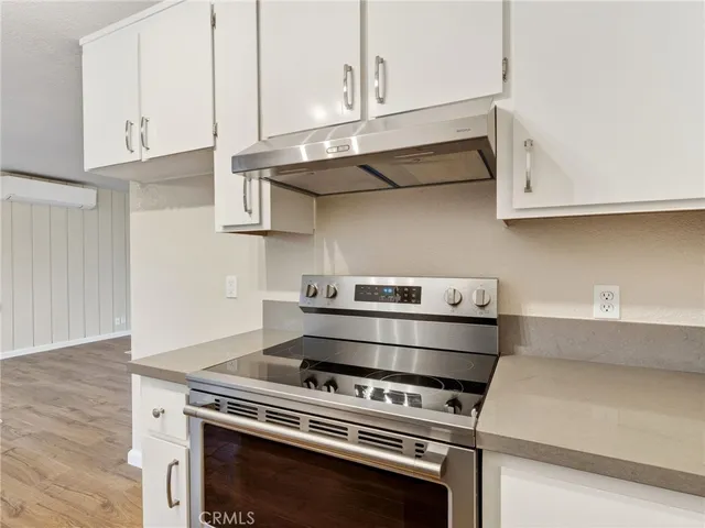 a stove top oven sitting inside of a kitchen