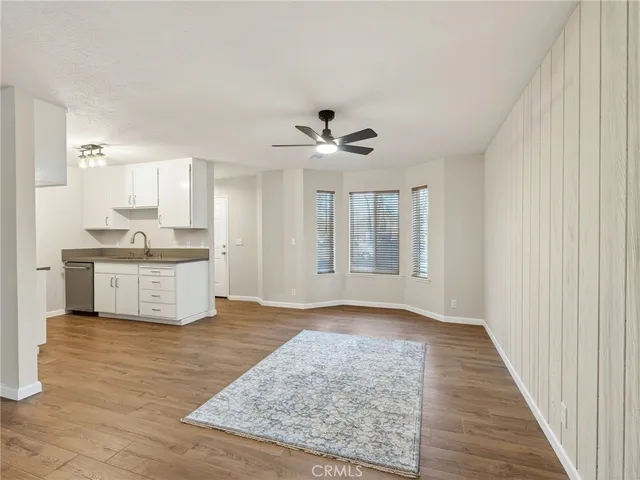 a view of kitchen with granite countertop cabinets and sink