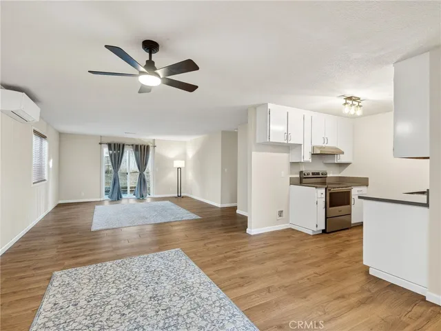 a kitchen with kitchen island white cabinets and stainless steel appliances