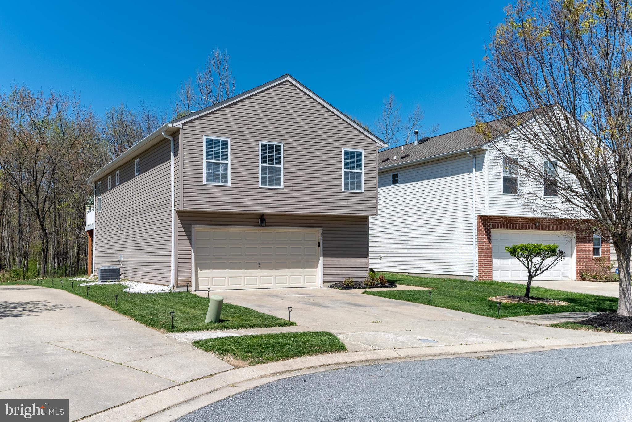 60 6 Point Court Baltimore, MD 21244 - Photo 4 of 28 a front view of a house with a yard and garage