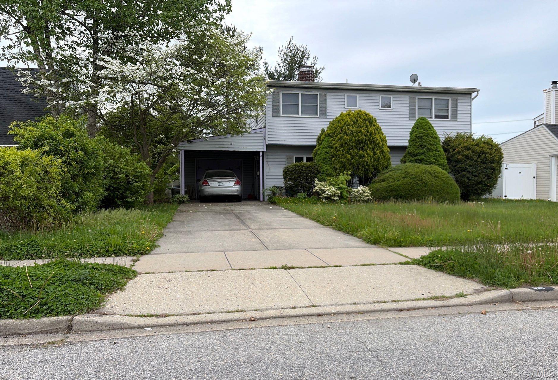 121 Farmedge Road Levittown, NY 11756 - Photo 1 of 4 a front view of a house with a yard and garage