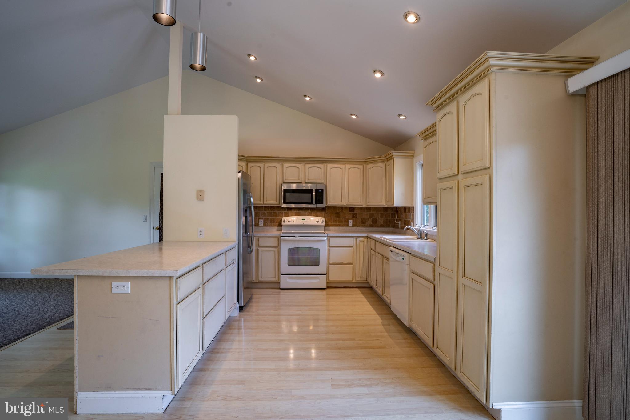 556 East Pleasantview Road Manheim, PA 17545 - Photo 52 of 93 a kitchen with stainless steel appliances kitchen island granite countertop a refrigerator a sink and a stove top oven