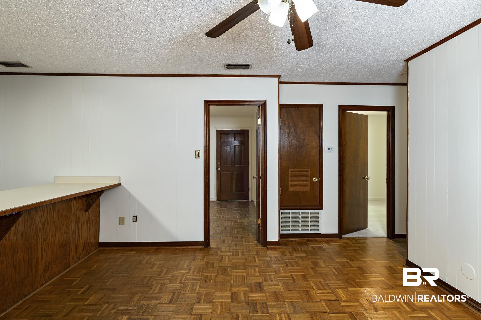 707 Johnson Avenue Fairhope, AL 36532 - Photo 17 of 38 Spare room featuring visible vents, baseboards, and ceiling fan