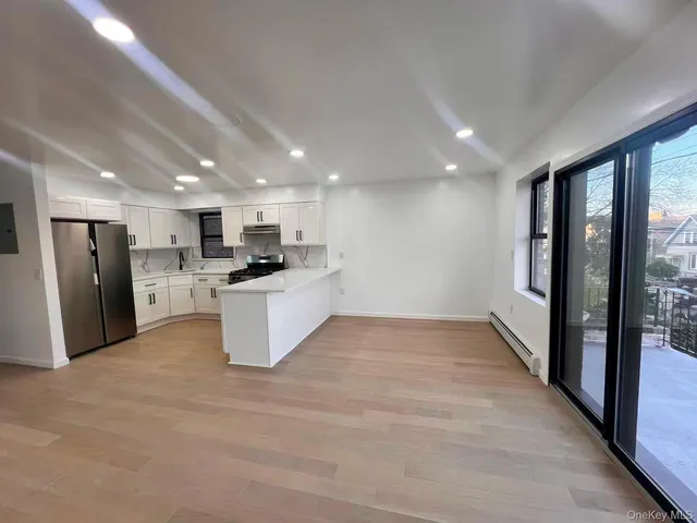 a view of kitchen with refrigerator and window