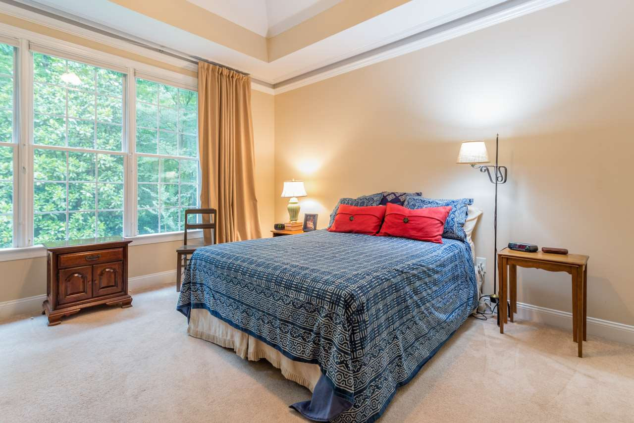 346 Rock Spring Road Wake Forest, NC 27587 - Photo 15 of 24 Master bedroom with two walk in closets serene view bath with glass shower and soaking tub