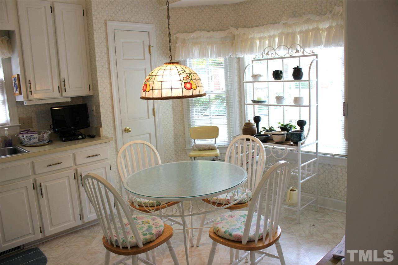 7920 Footman Way Raleigh, NC 27615 - Photo 11 of 25 a kitchen with a table and chairs