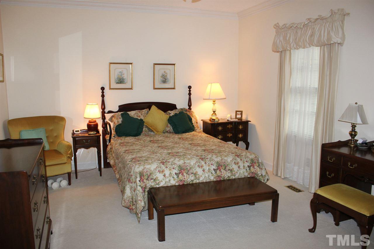 7920 Footman Way Raleigh, NC 27615 - Photo 15 of 25 a bedroom with a bed chair and window