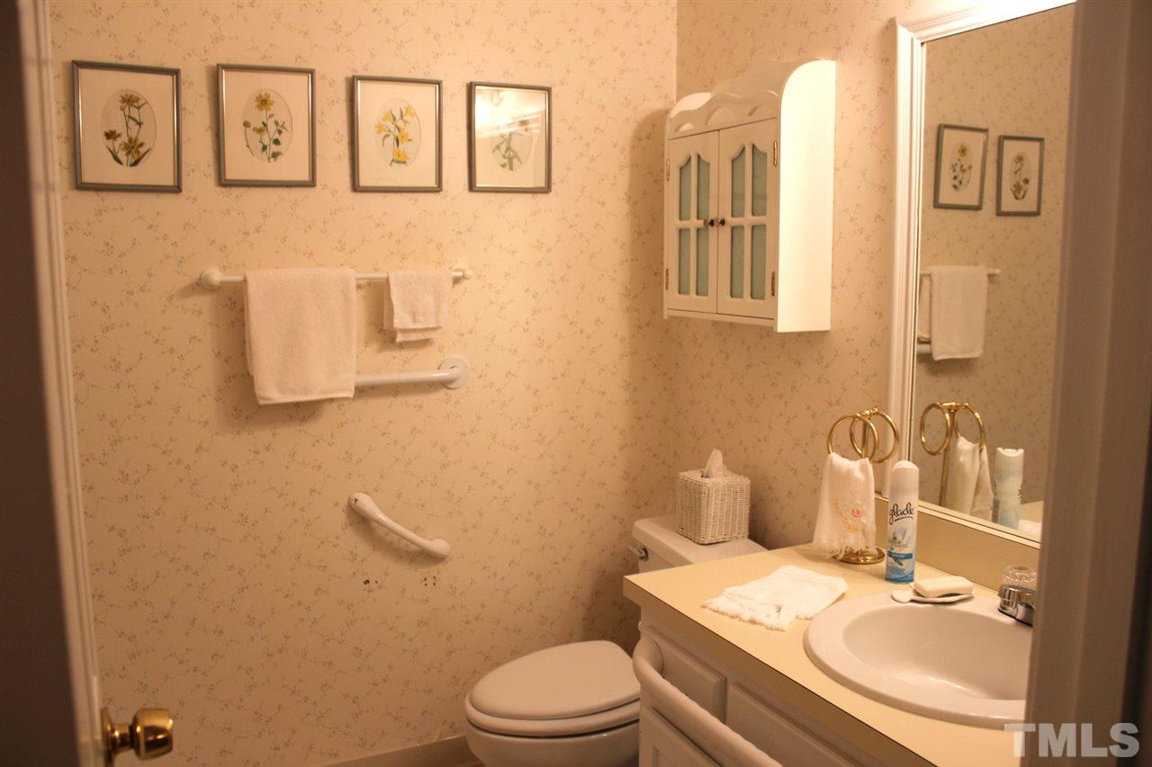 7920 Footman Way Raleigh, NC 27615 - Photo 16 of 25 a bathroom with a granite countertop toilet sink and mirror