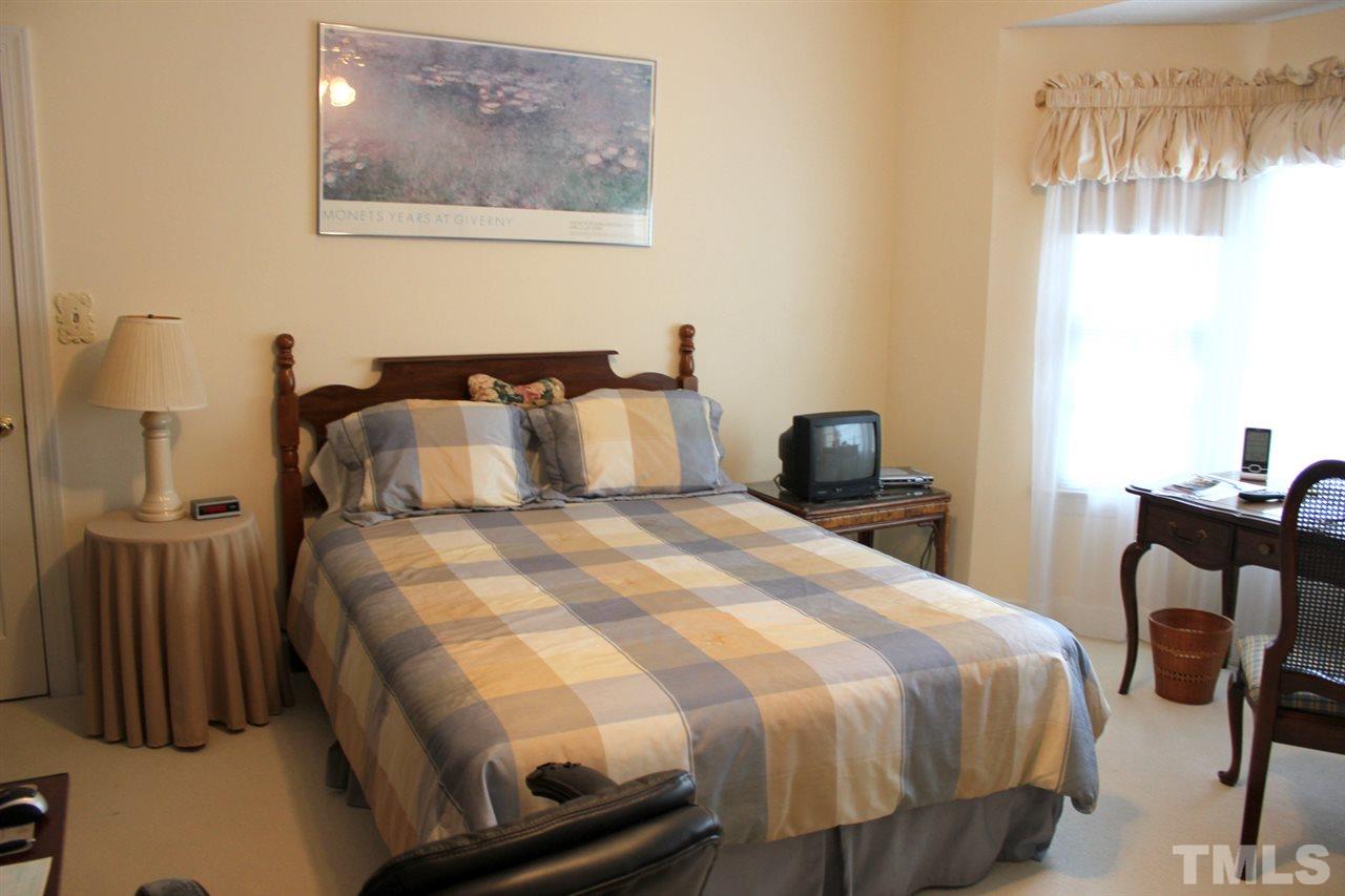 7920 Footman Way Raleigh, NC 27615 - Photo 17 of 25 a bedroom with a bed and chair