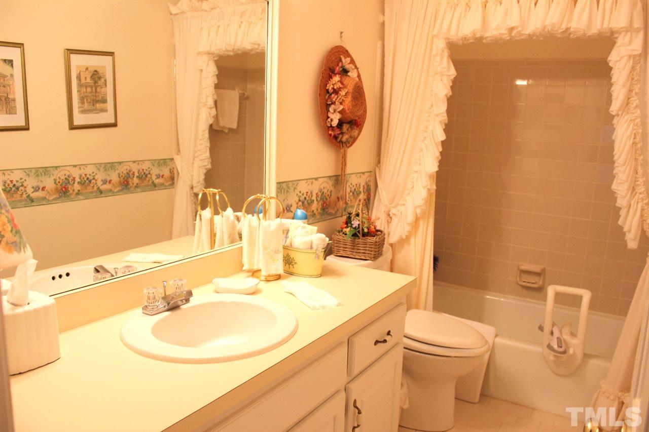 7920 Footman Way Raleigh, NC 27615 - Photo 20 of 25 a bathroom with a toilet sink and mirror