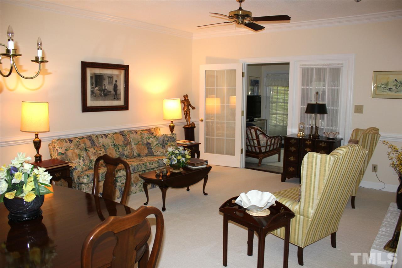 7920 Footman Way Raleigh, NC 27615 - Photo 4 of 25 a living room with furniture and wooden floor