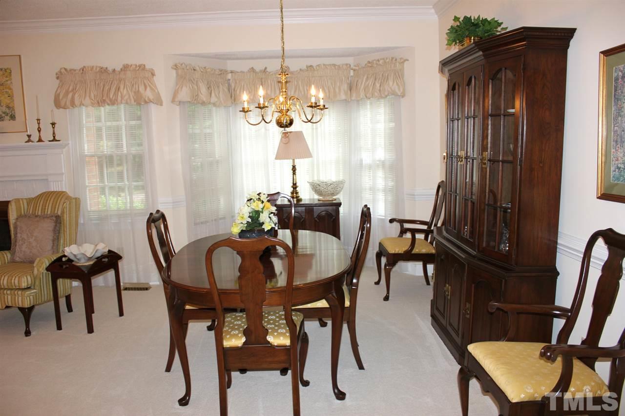 7920 Footman Way Raleigh, NC 27615 - Photo 5 of 25 a view of a dining room with furniture and chandelier