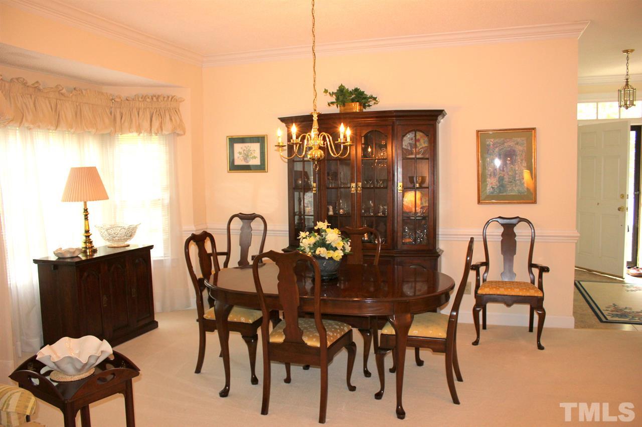 7920 Footman Way Raleigh, NC 27615 - Photo 6 of 25 a view of a dining room with furniture and chandelier