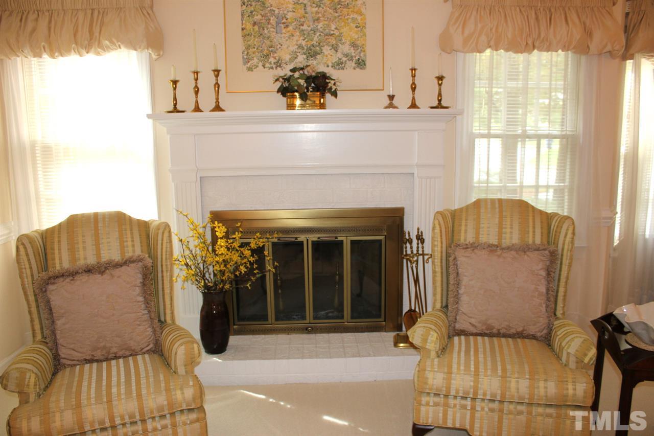 7920 Footman Way Raleigh, NC 27615 - Photo 8 of 25 a living room with furniture and a fireplace