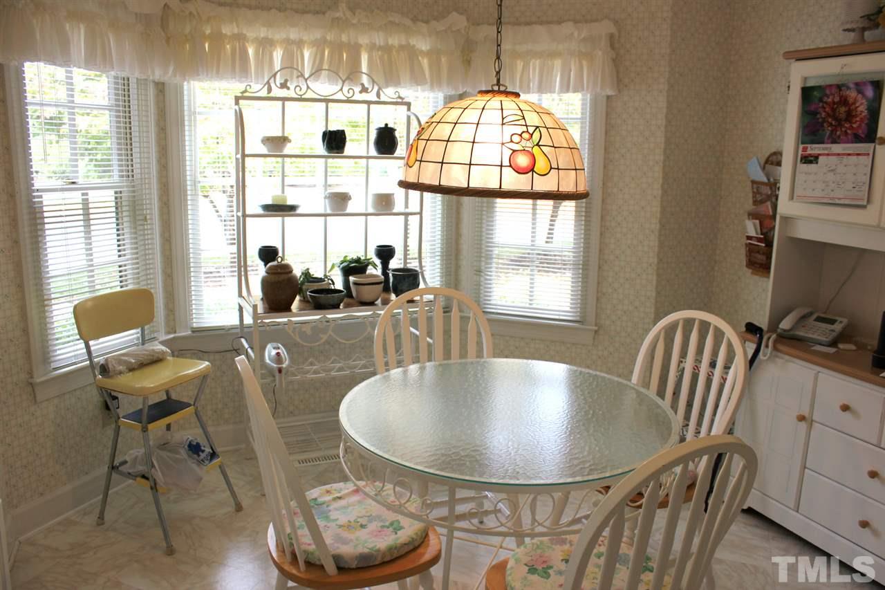 7920 Footman Way Raleigh, NC 27615 - Photo 10 of 25 a view of a dining room with furniture window and outside view