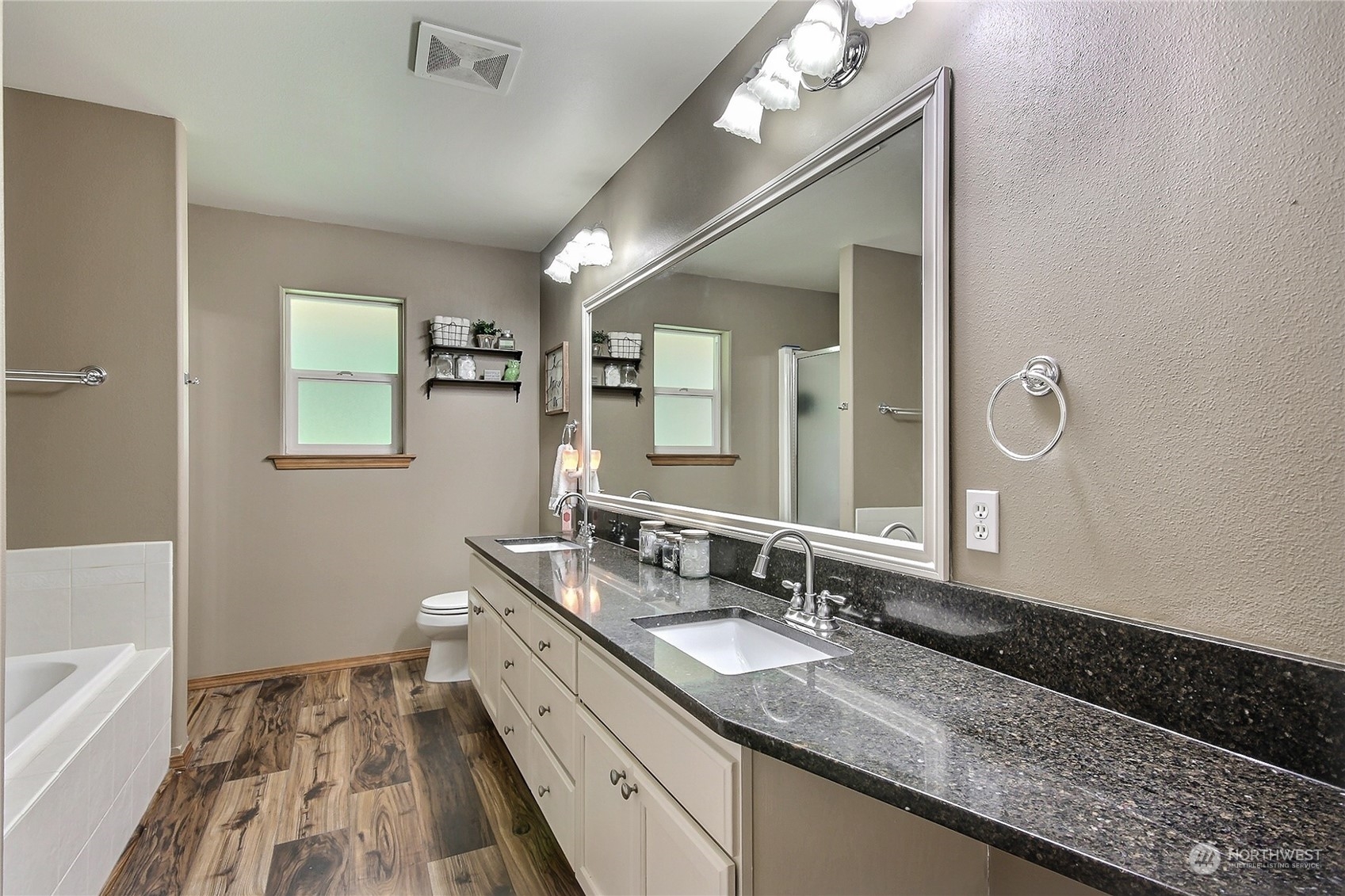 17502 Littlerock Road Southwest Rochester, WA 98579 - Photo 13 of 20 a bathroom with a granite countertop double vanity sink a mirror and a bathtub