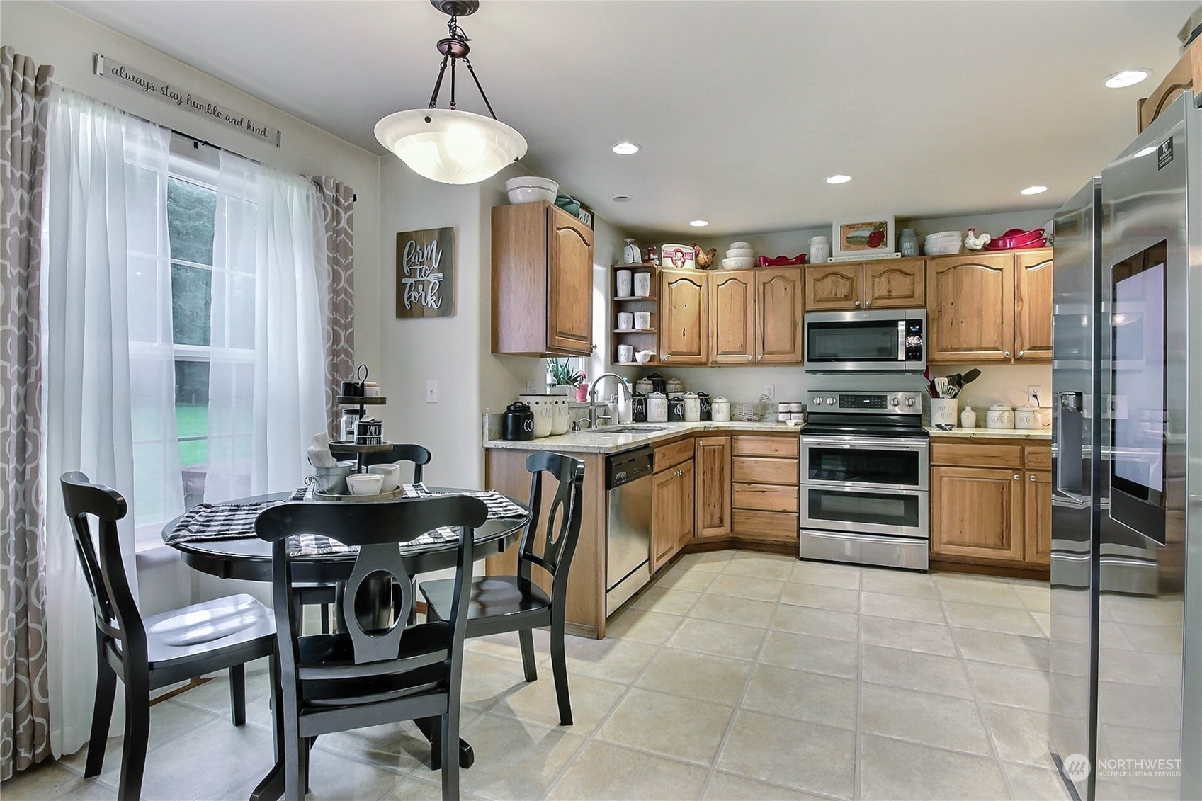 17502 Littlerock Road Southwest Rochester, WA 98579 - Photo 7 of 20 a kitchen with stainless steel appliances kitchen island granite countertop a sink and cabinets