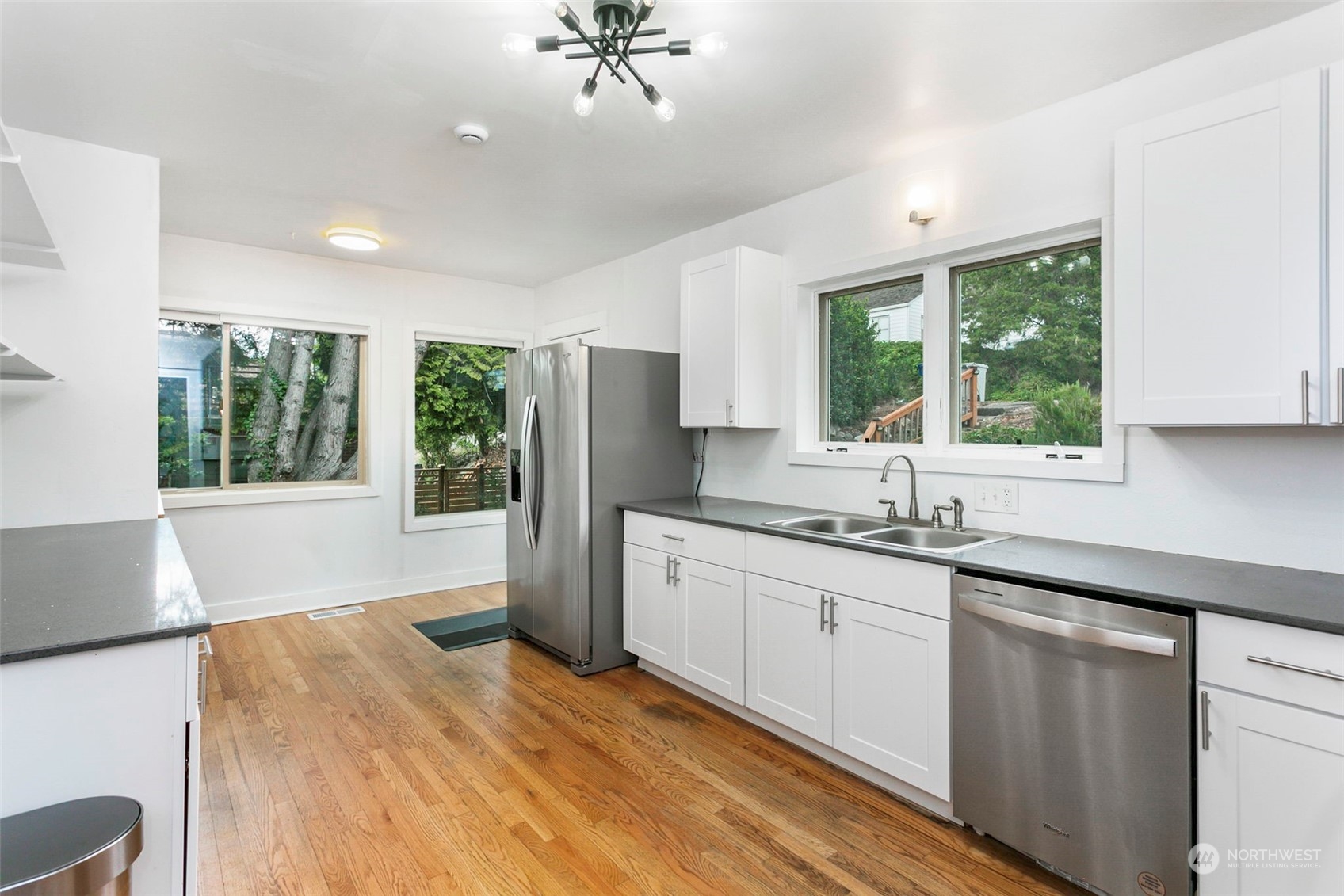 710 Prospect Avenue North Kent, WA 98031 - Photo 11 of 37 a kitchen with granite countertop a sink stainless steel appliances cabinets and a large window