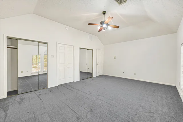 a bathroom with a double vanity sink mirror and shower