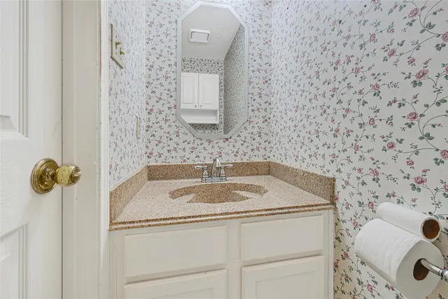 a view of an empty room with a fireplace and a window