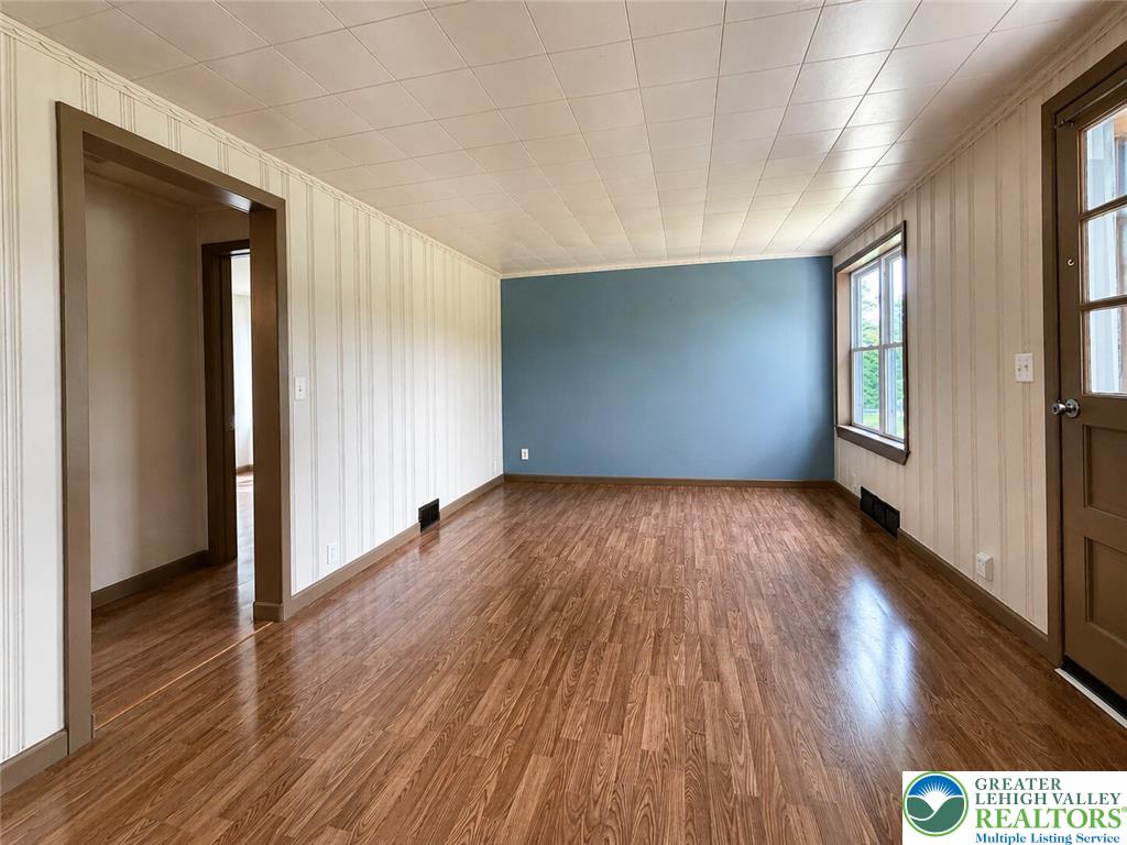 4995 Mountain Road Slatington, PA 18080 - Photo 6 of 30 A versatile living space with polished wood-look flooring and a unique accent wall awaits your personal touch.