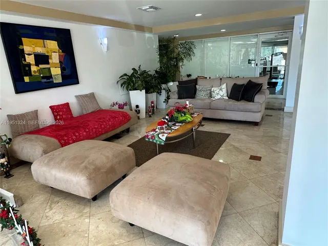 a living room with furniture and painting on wall