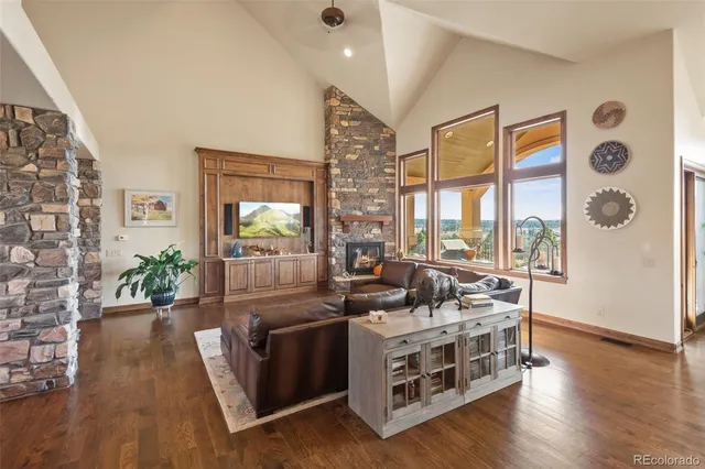a view of living room kitchen with furniture and wooden floor