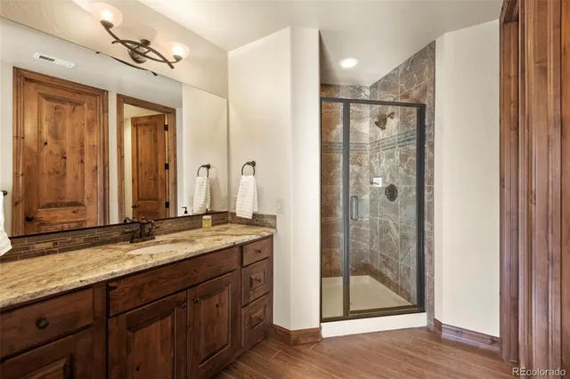 a large bed sitting in a bedroom next to a window