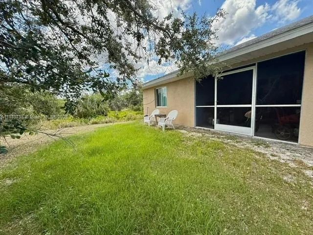 a backyard of a house with table and chairs