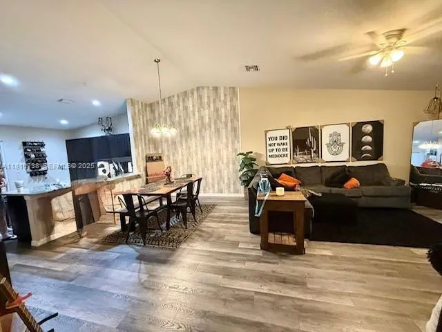 a living room with furniture a dining table and kitchen view