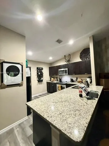 a kitchen with sink and refrigerator